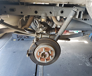 Auto shop fixing wheel alignment